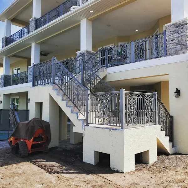 Decorative railing on stairs and on second and third floors of home.