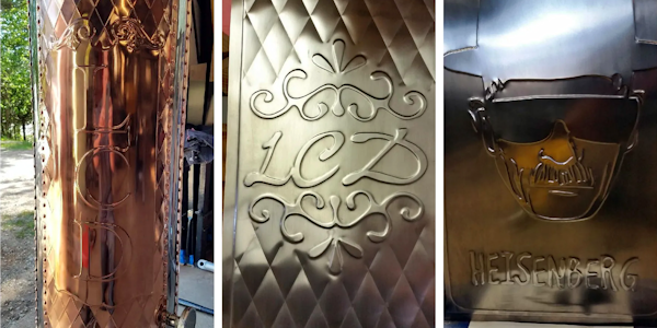 Copper stove pipes with decorative raised letters and patterns.